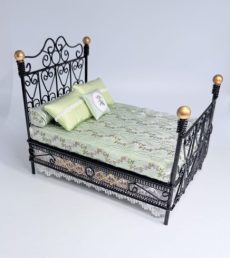 Black iron double bed with gold knob accents