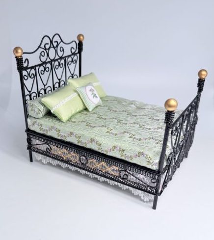 Black iron double bed with gold knob accents